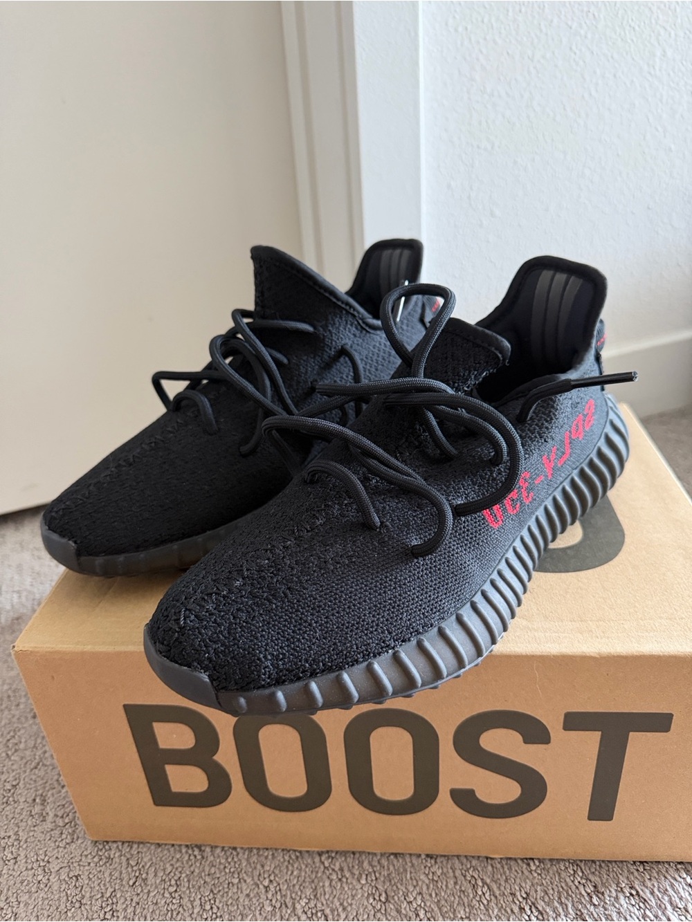Yeezy Black Athletic Sneakers with Red Accent